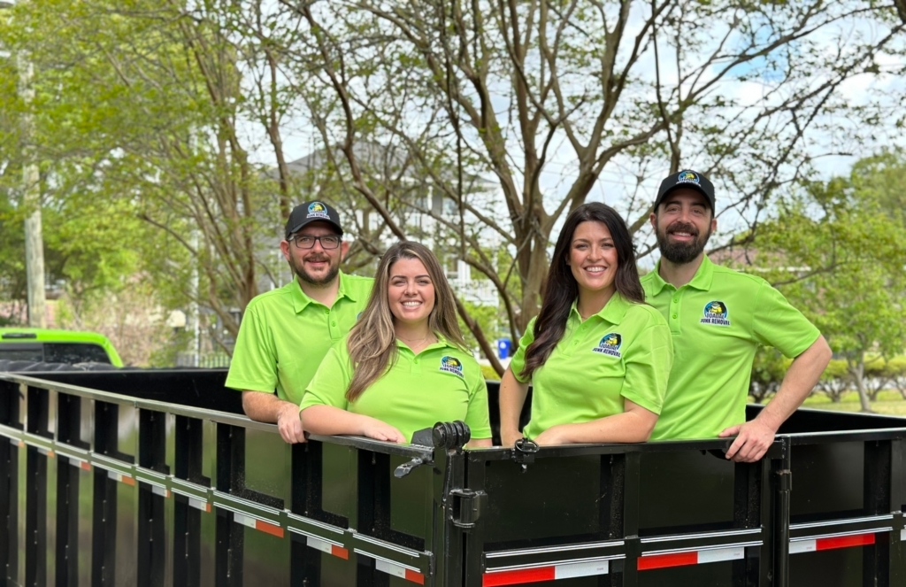 The Toadal Junk Removal crew posing in a junk truck