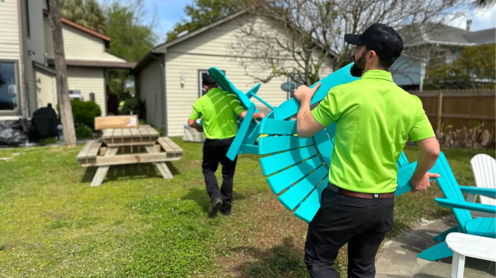 Two Toadal Junk employees carrying lawn chairs.