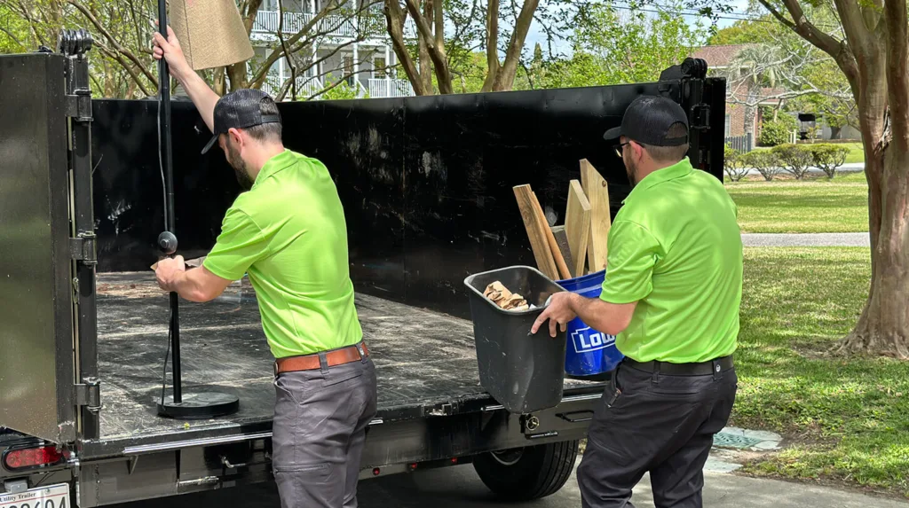 Two Toadal Junk employees prepping truck bed.